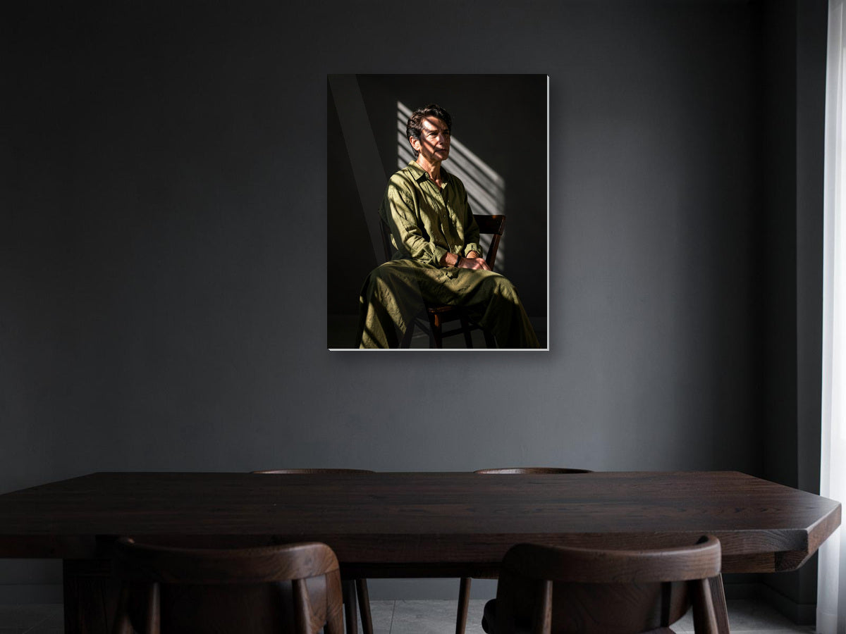 seated figure metal print displayed in a room